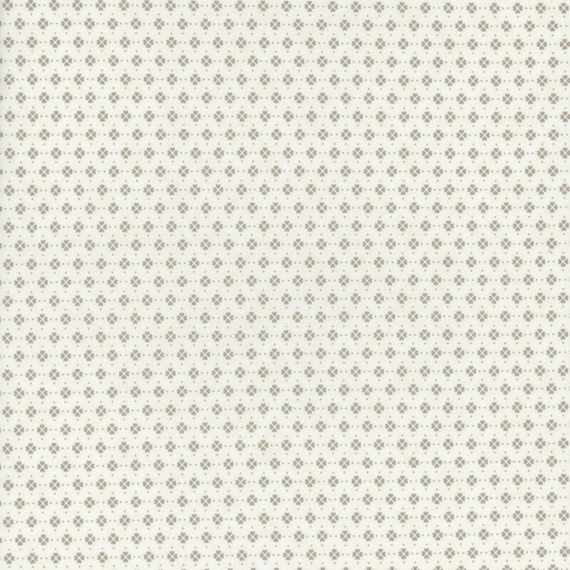 This fabric features clusters of beige clover motifs in rows on a solid cream background.