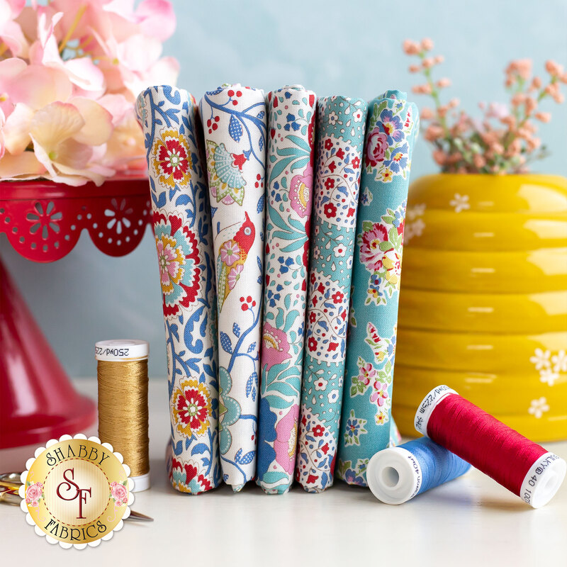 stack of fabrics included in Jubilee teal and white 5 fat quarter set