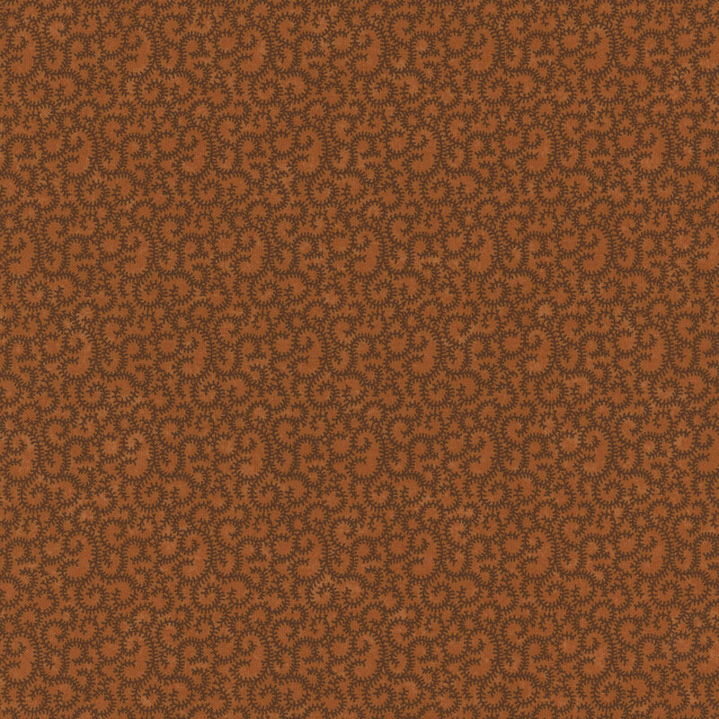 burnt orange fabric featuring swirling brown vines