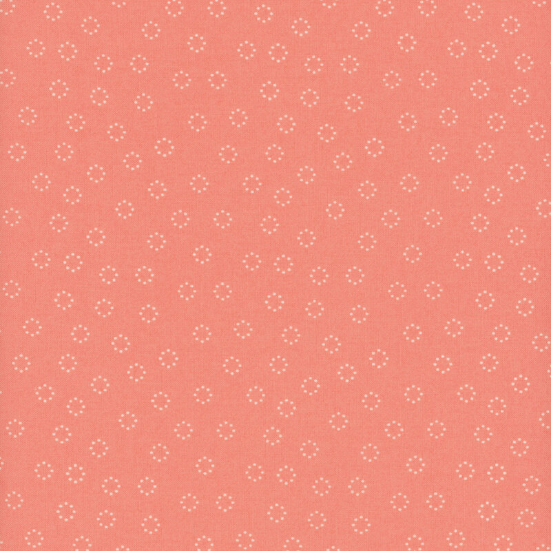 fabric featuring cream white dotted circles tossed on a solid lovely pink background.