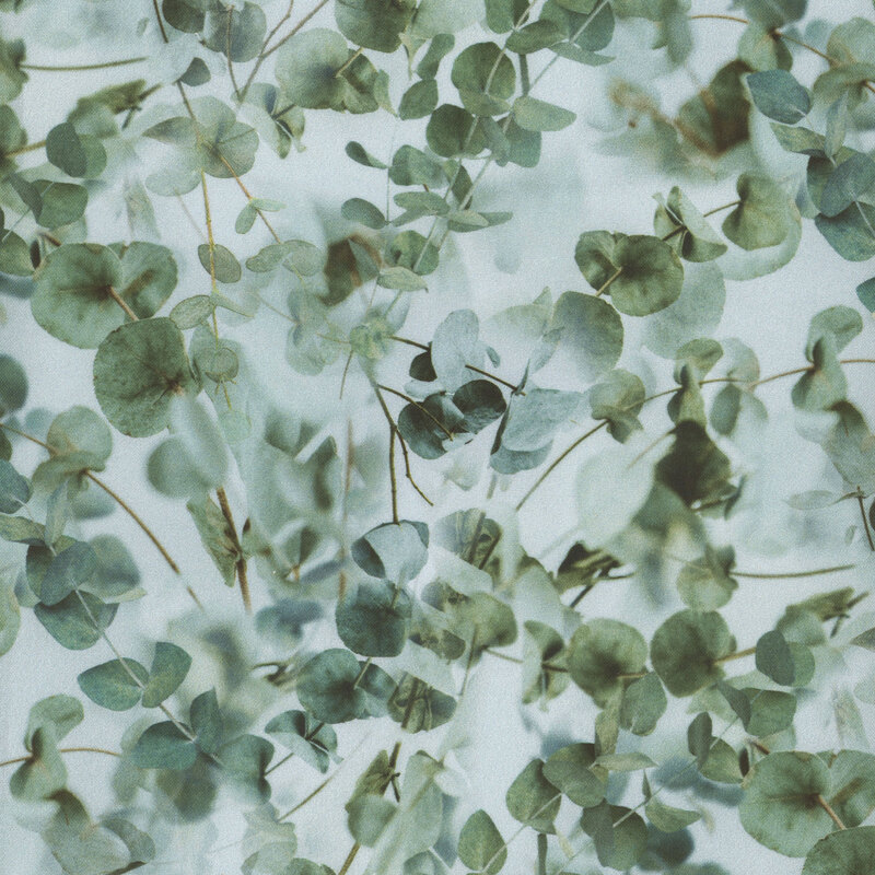 minty green fabric covered in eucalyptus branches