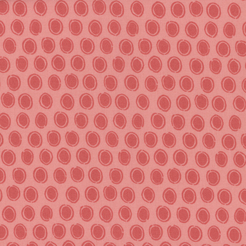 dark pink fabric featuring rows of darker faded red ovals surrounded by sketched circles