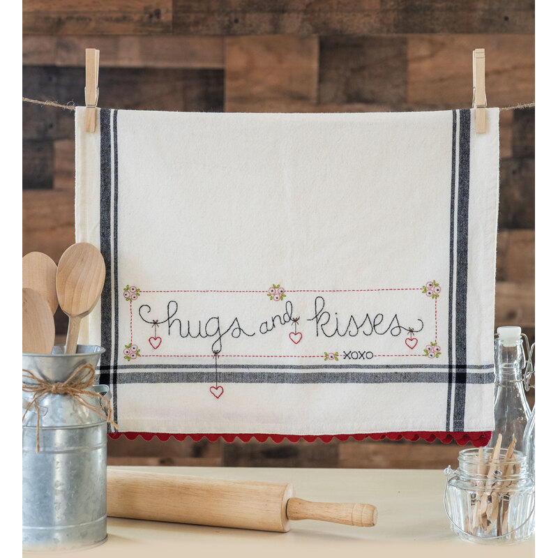 vintage style kitchen towel with heart embroidery along with the phrase 