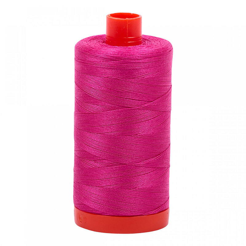 A spool of Aurifil 4020 - Fuchsia thread on a white background