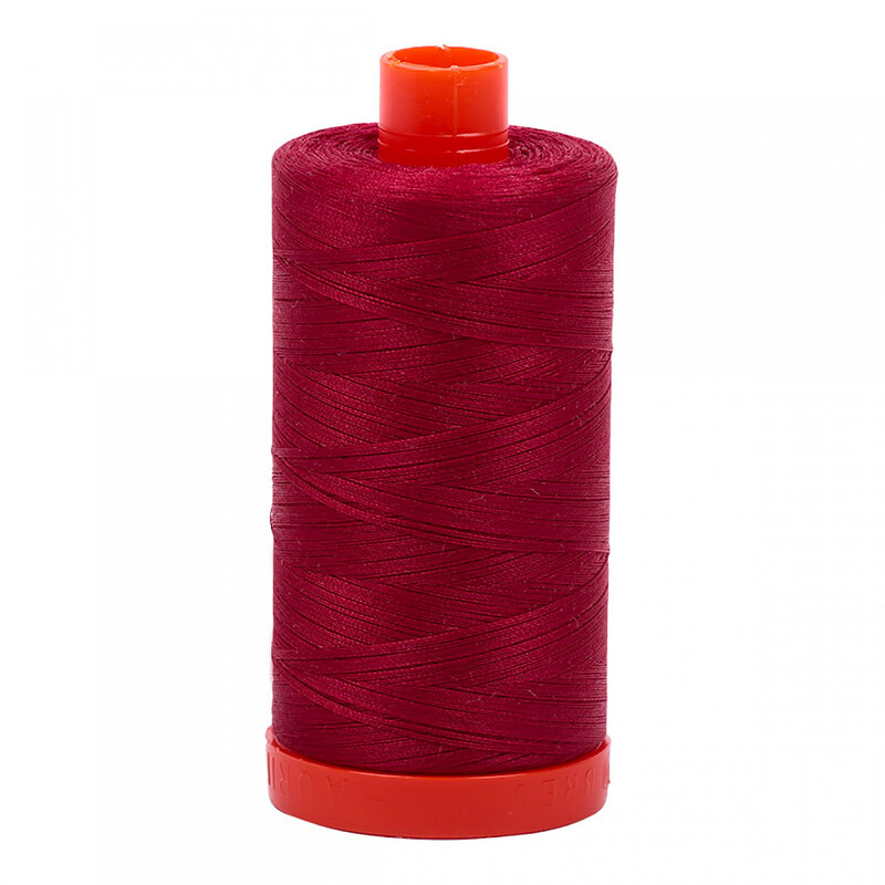 A spool of Aurifil 1103 - Burgundy thread on a white background