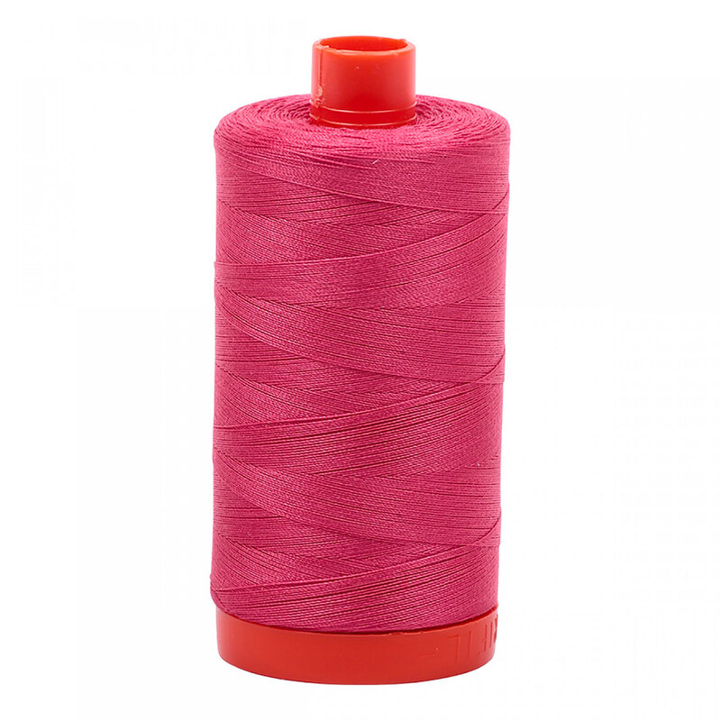 A spool of Aurifil 2440 - Peony thread on a white background