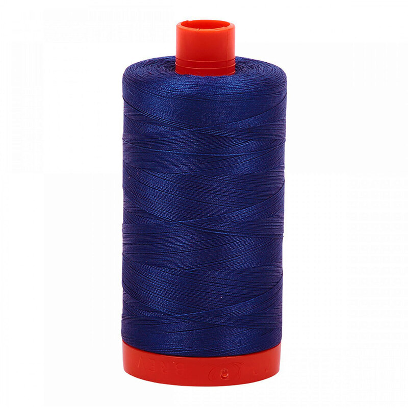 A spool of Aurifil 2740 - Dark Cobalt thread on a white background