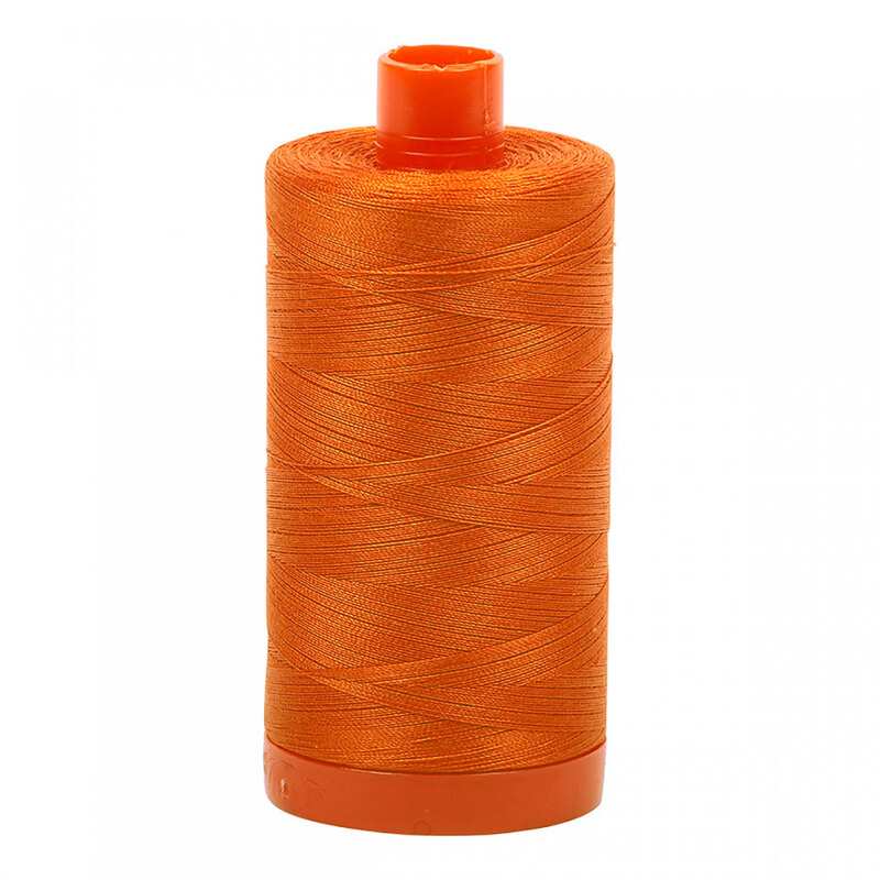 A spool of Aurifil 2150 - Pumpkin thread on a white background