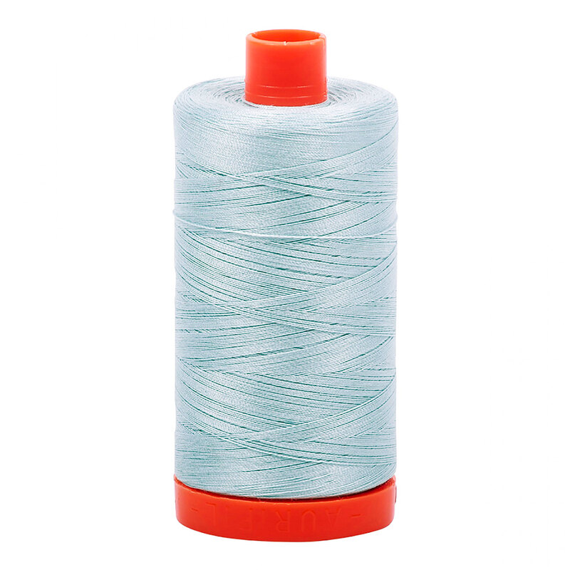 A spool of Aurifil 2846 -Iceberg thread on a white background