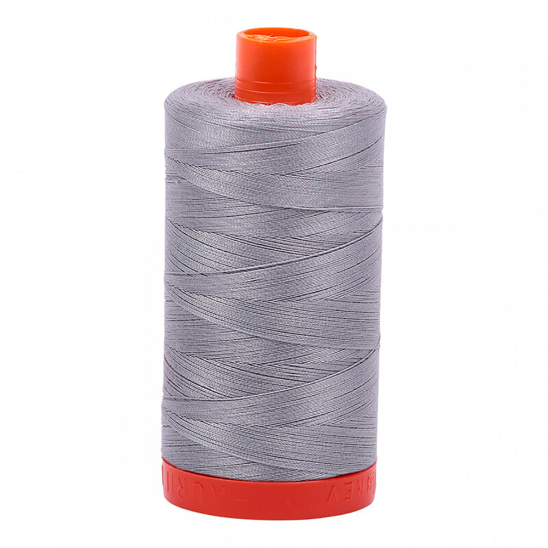 A spool of Aurifil 2606 -Mist thread on a white background