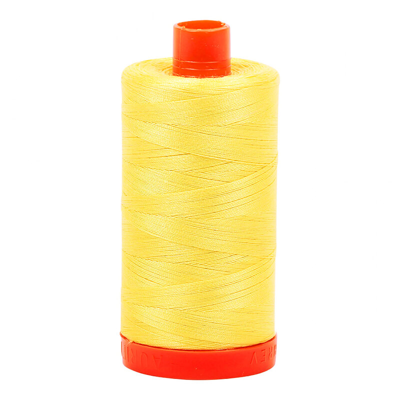 A spool of Aurifil 2115 -Lemon thread on a white background