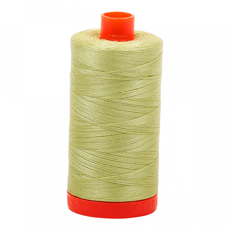 A spool of Aurifil 2886 -Light Avocado thread on a white background