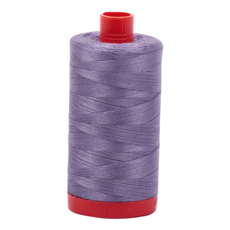 A spool of Aurifil 6733 - Twilight thread on a white background