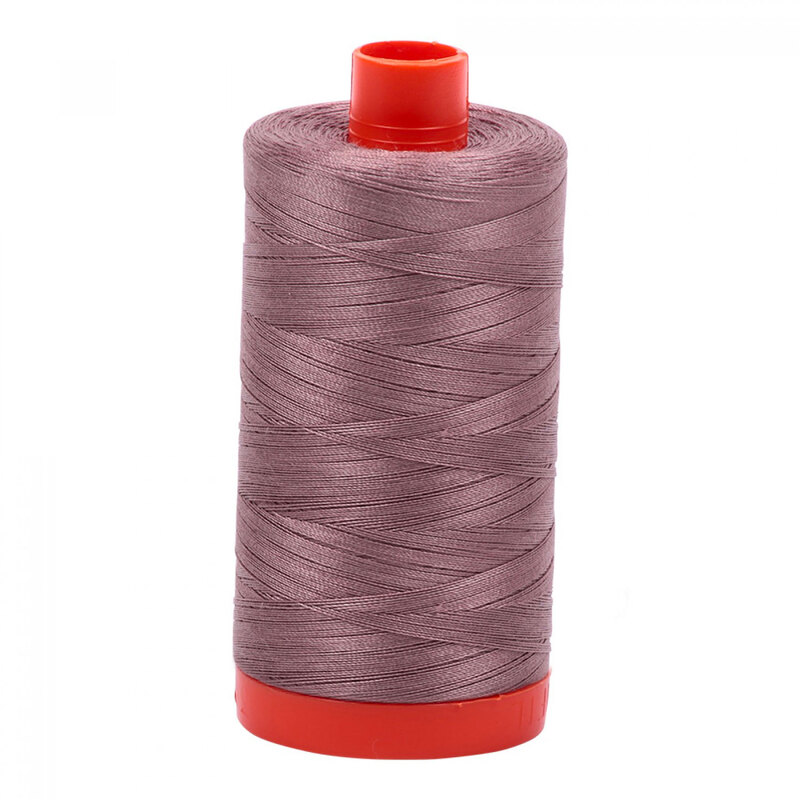 A spool of Aurifil 6731 - Tiramisu thread on a white background