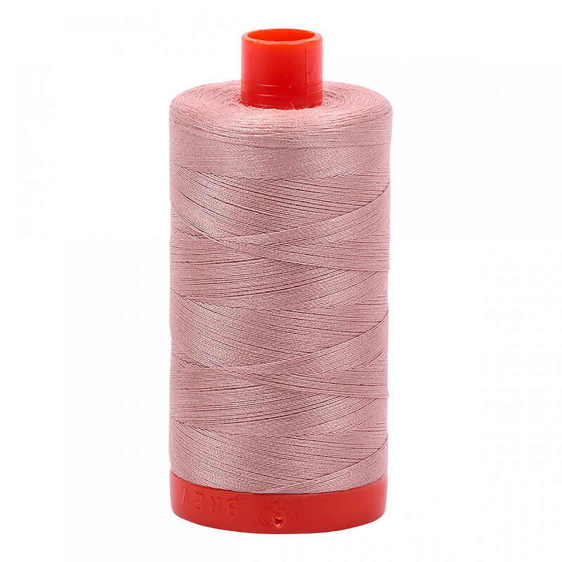 A spool of Aurifil 2375 - Antique Blush thread on a white background