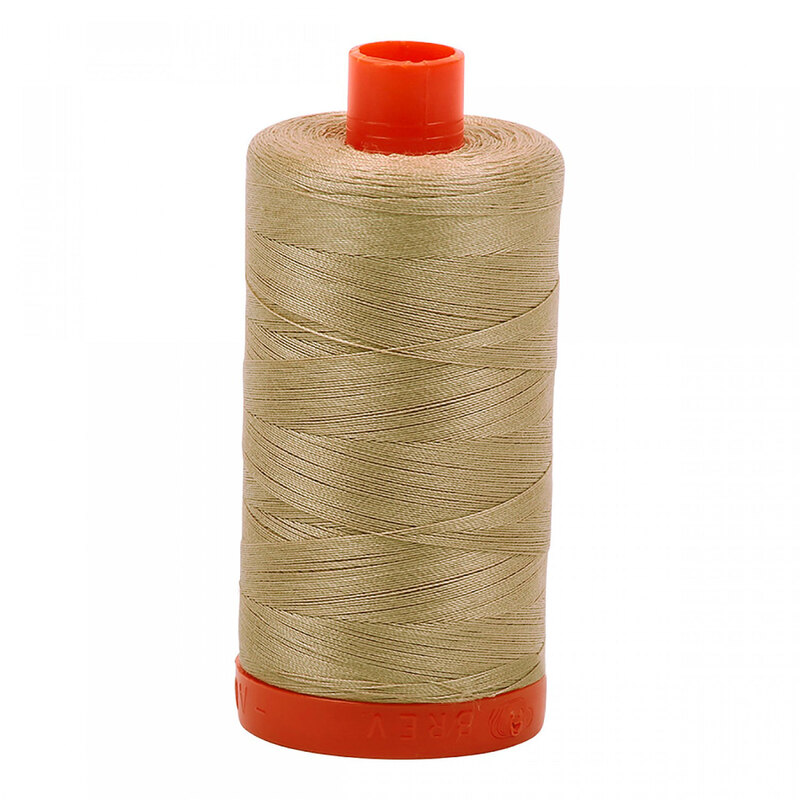 A spool of Aurifil 2326 - Sand thread on a white background