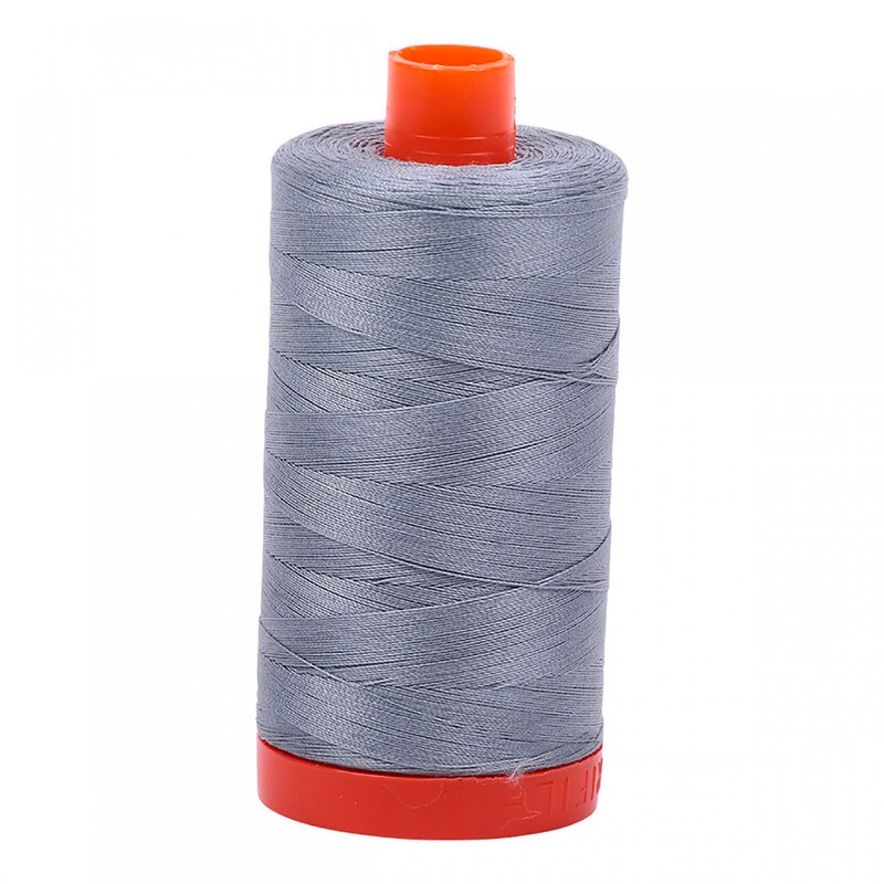 A spool of Aurifil 2610 -Light Blue Grey thread on a white background