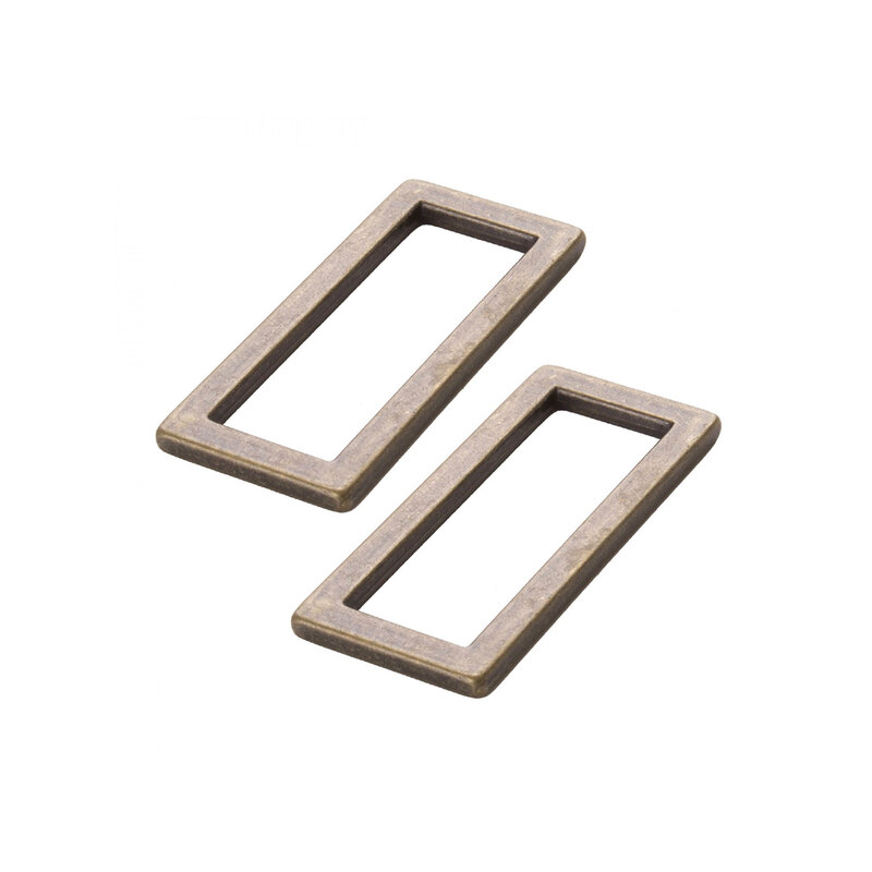 2 antique brass finished metal rectangle rings on a white background