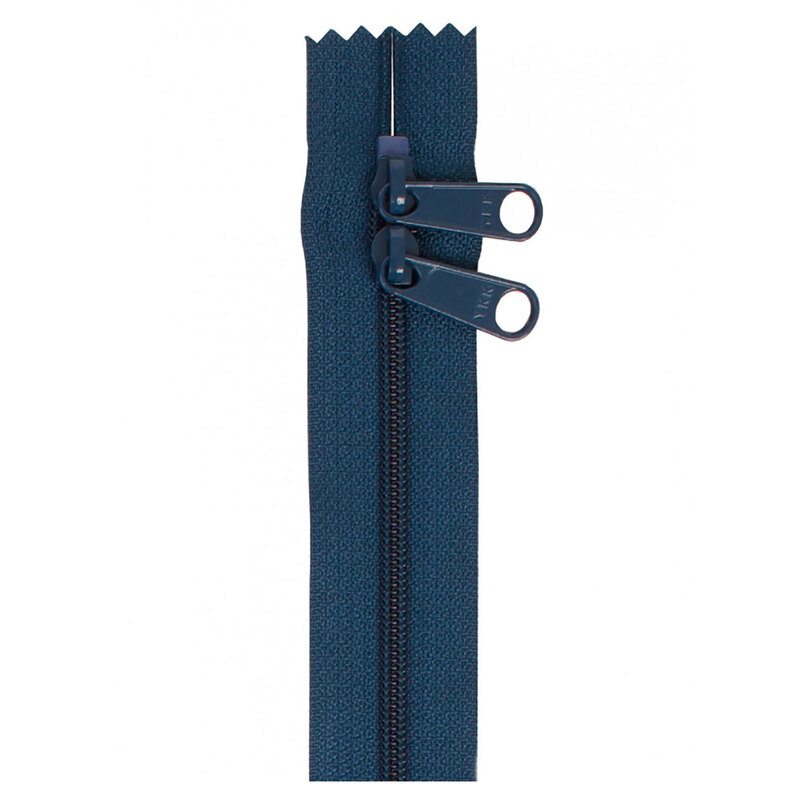 Photo of a dark blue zipper with two pull tabs isolated on a white background