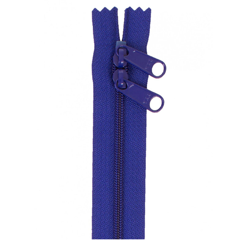 Photo of a dark blue zipper with two pull tabs isolated on a white background