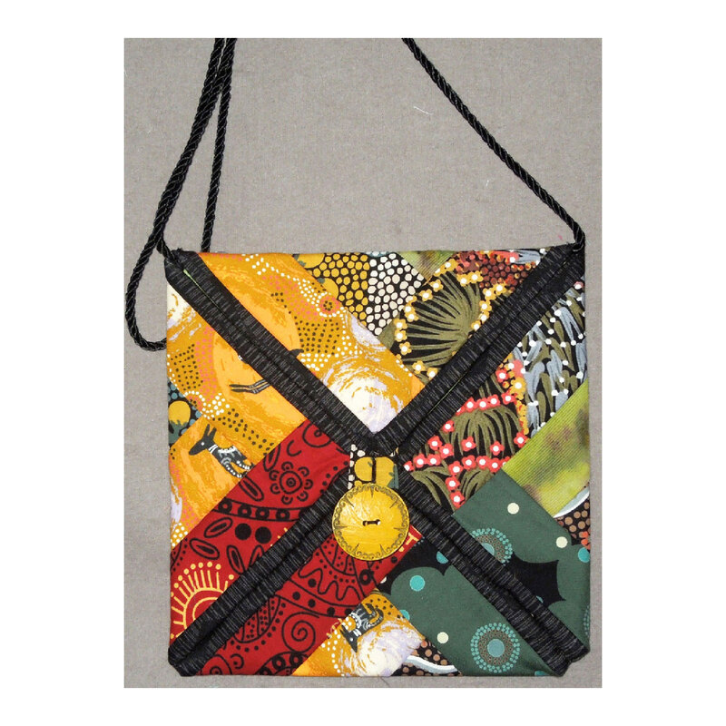 Photograph of a finished small bag made with multicolor fabric and black bordering