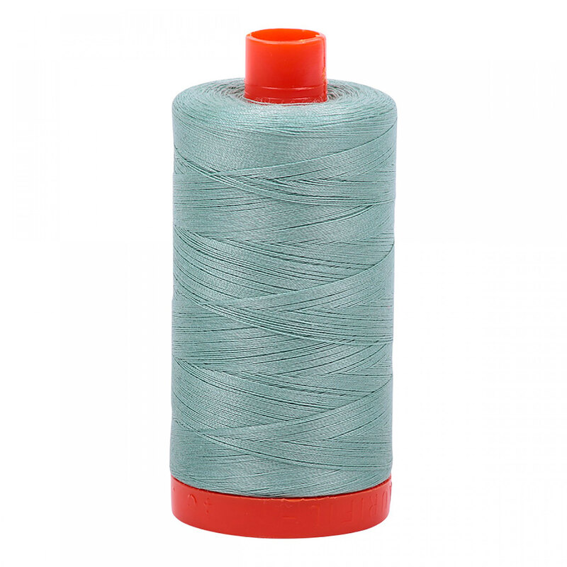 A spool of Aurifil 2845 - Light Juniper thread in a sage green tone on a bright orange spool, a white background