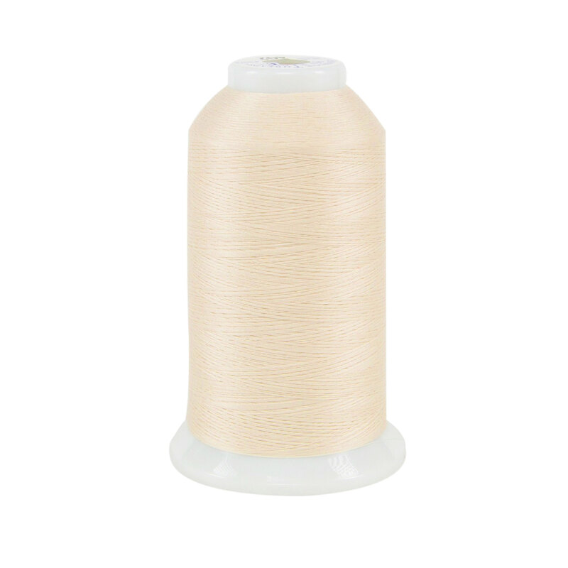 Spool of cream So Fine! thread on a white background