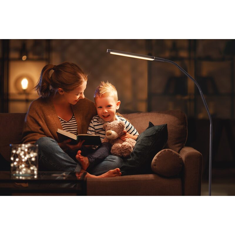 Woman and child reading with the lamp