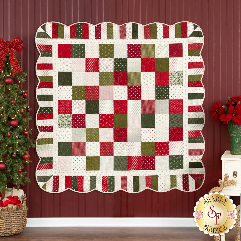 Handmade Christmas quilt good or wall hanging made from cheerful holiday fabrics, red flannel back, machine quilted in a holiday light pattern