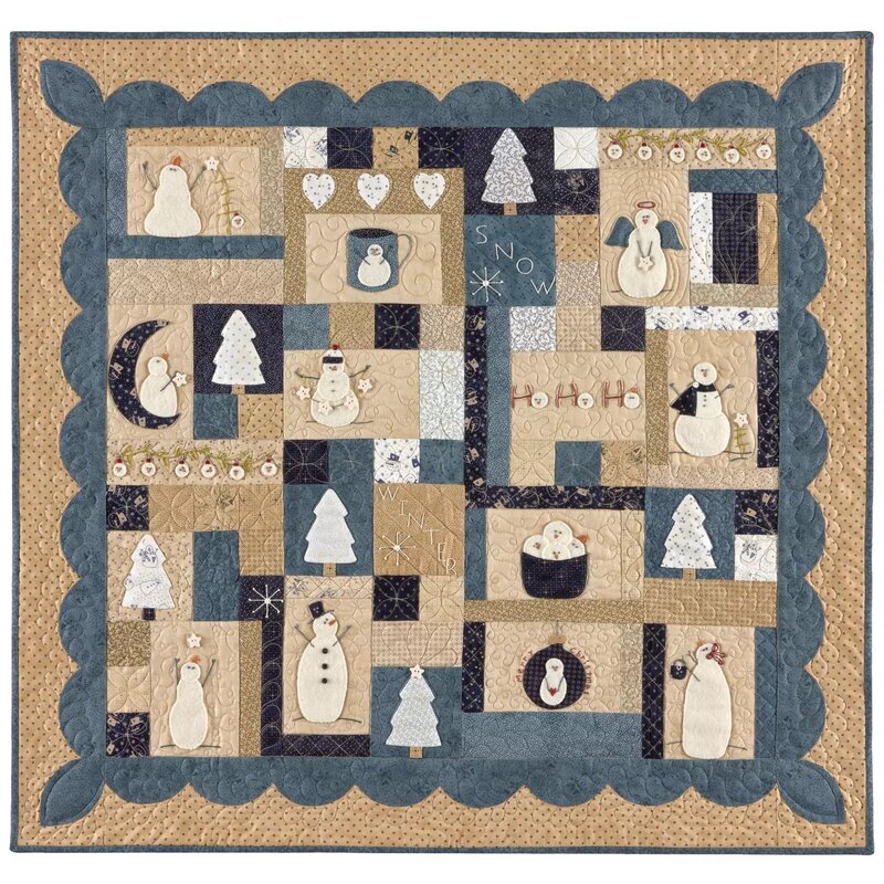 Front of pattern showing the completed quilt in wool in a blue, tan, and cream color palette