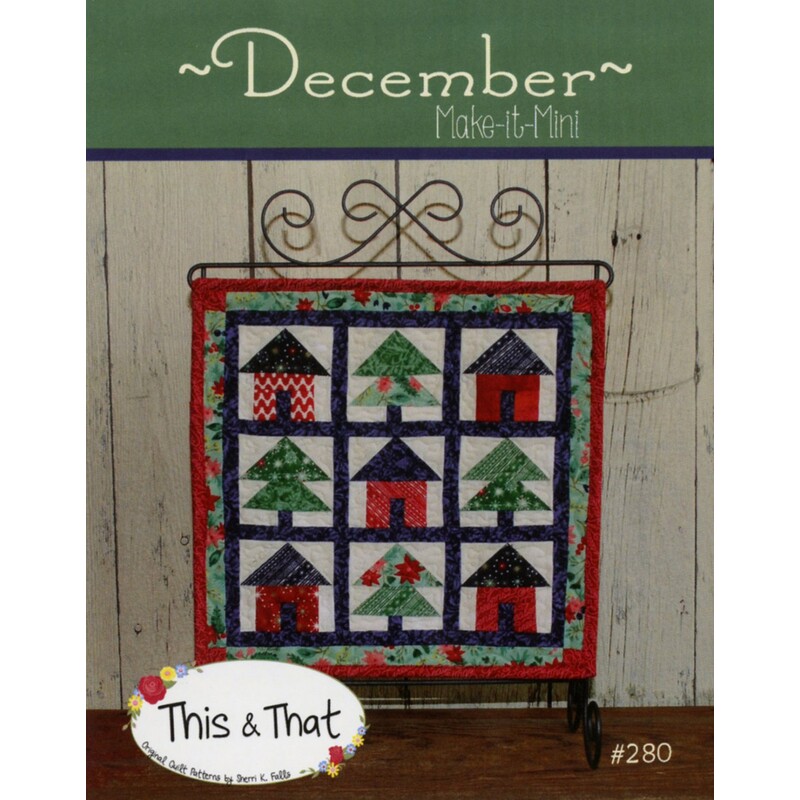 Front cover of pattern, showing the finished wallhanging hung from a craft scroll, staged in front of wood panels