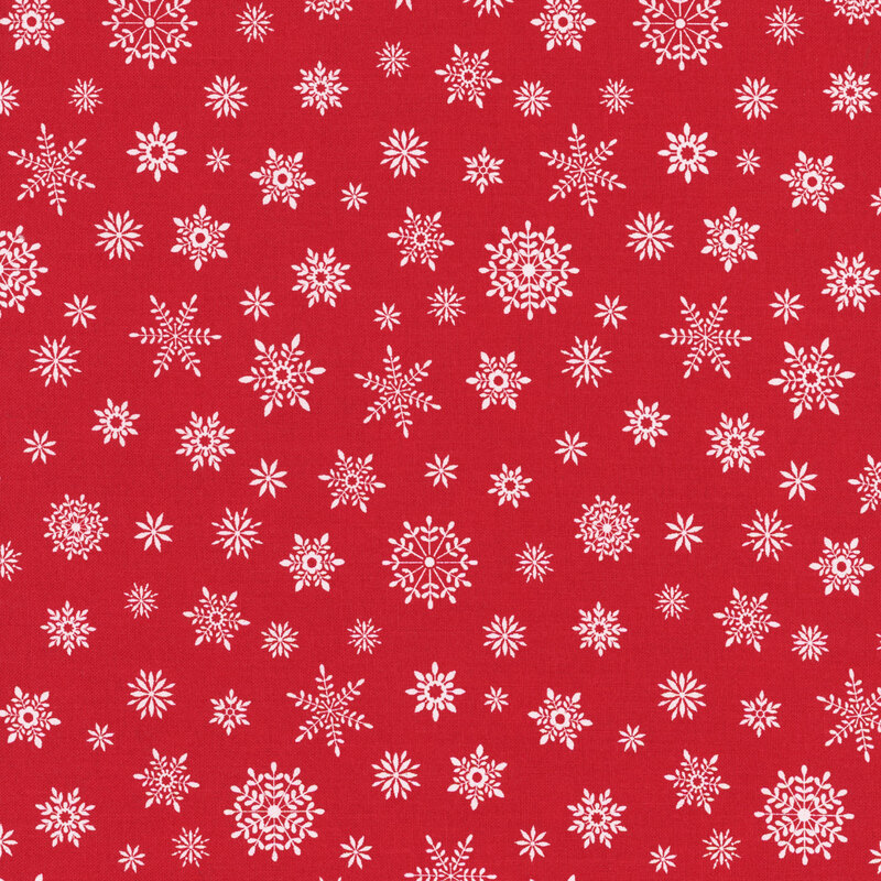 Small white snowflakes on a bright red fabric.