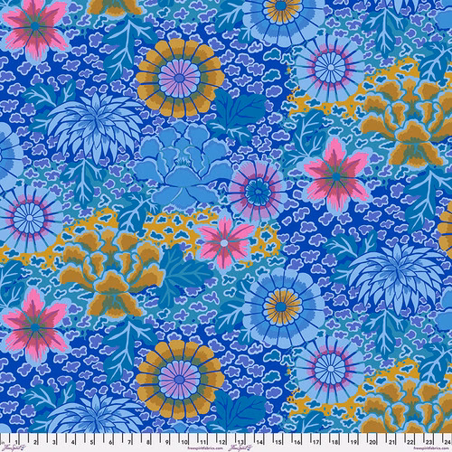 Fabric featuring vibrant blue, pink, and mustard yellow flowers over a blue and teal background with abstract blue and teal dots