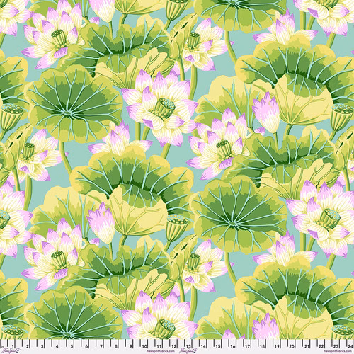 Fabric featuring vibrant pink, white, and yellow lotus blossoms and vivid green leaves over a dusty blue background