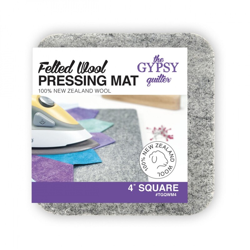 A square wool pressing mat with packaging, featuring an iron and colorful fabric squares.