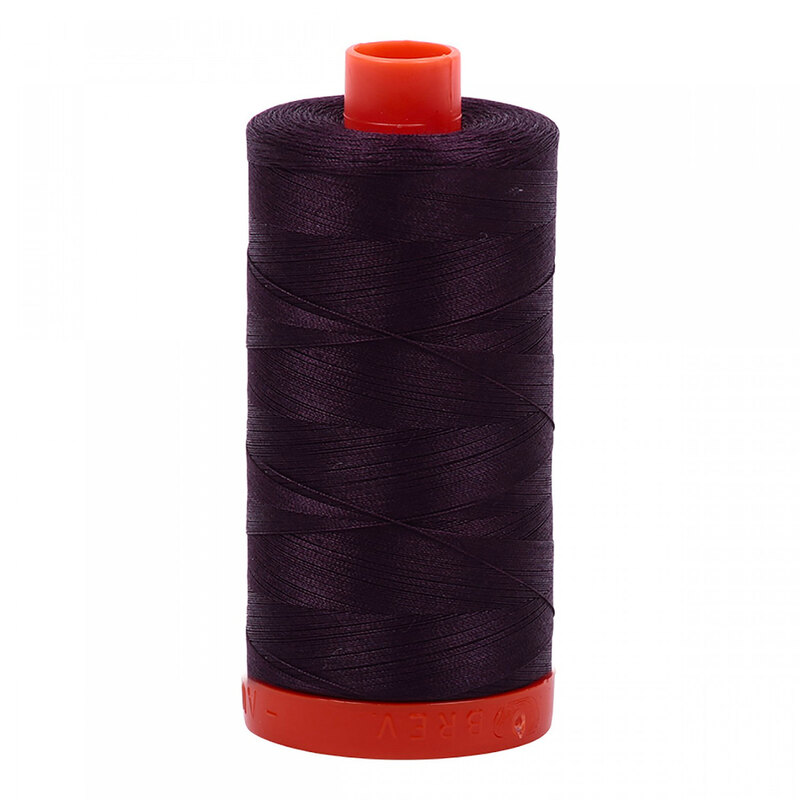 A spool of Aurifil 2570 - Aubergine thread on a white background