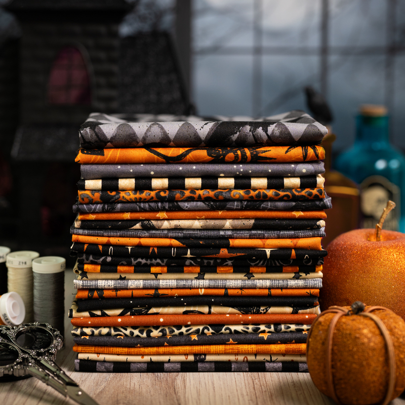 photography of the 24 SKUs in the Nevermore collection, warm toned orange, cream, black, and gray dressed in halloween decor