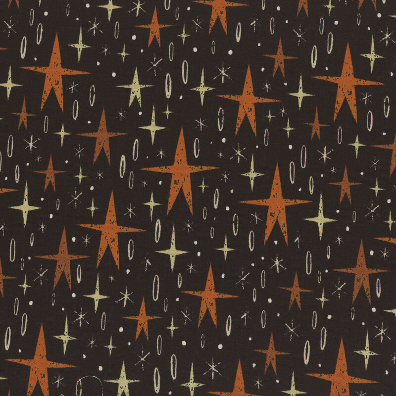 rich black fabric, featuring stylized orange stars, alongside various light yellow star motifs