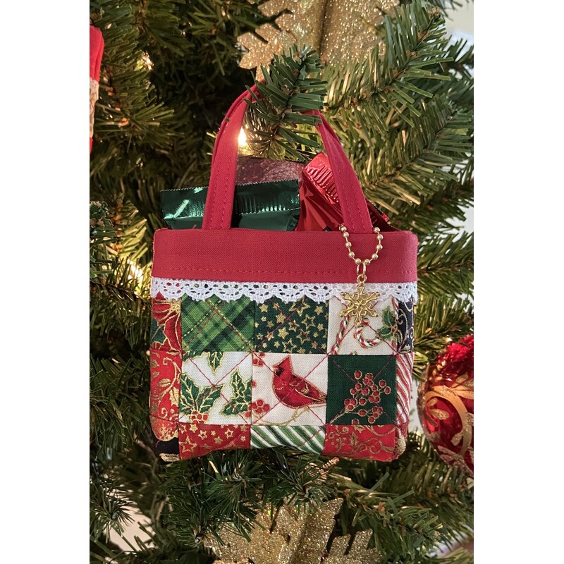 Tiny patchwork fabric tote designed by Joyce Minnis displayed on Christmas tree