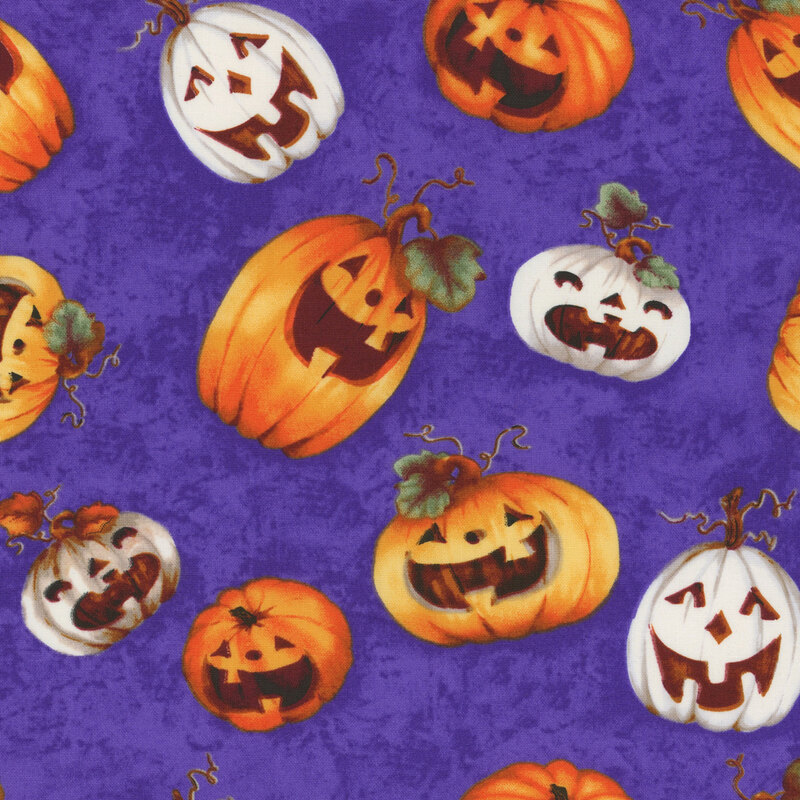 delightful indigo mottled fabric with scattered white and orange jack o' lanterns