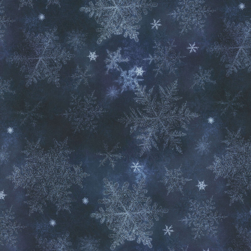 navy blue mottled fabric featuring scattered light blue snowflakes