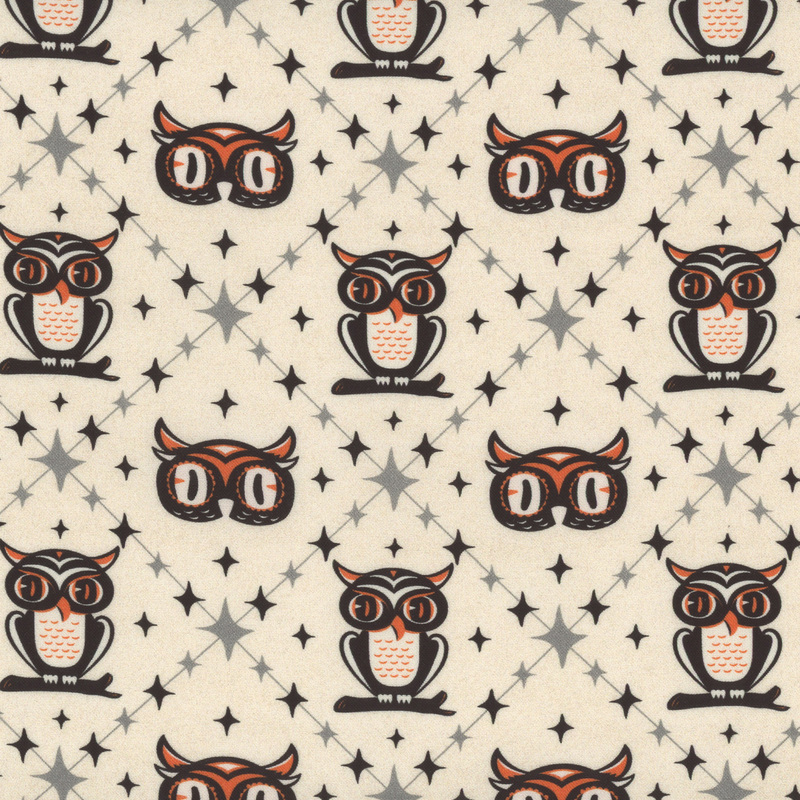 white fabric with a square on point design surrounding stylized owls and owl heads amidst scattered 4-pointed stars