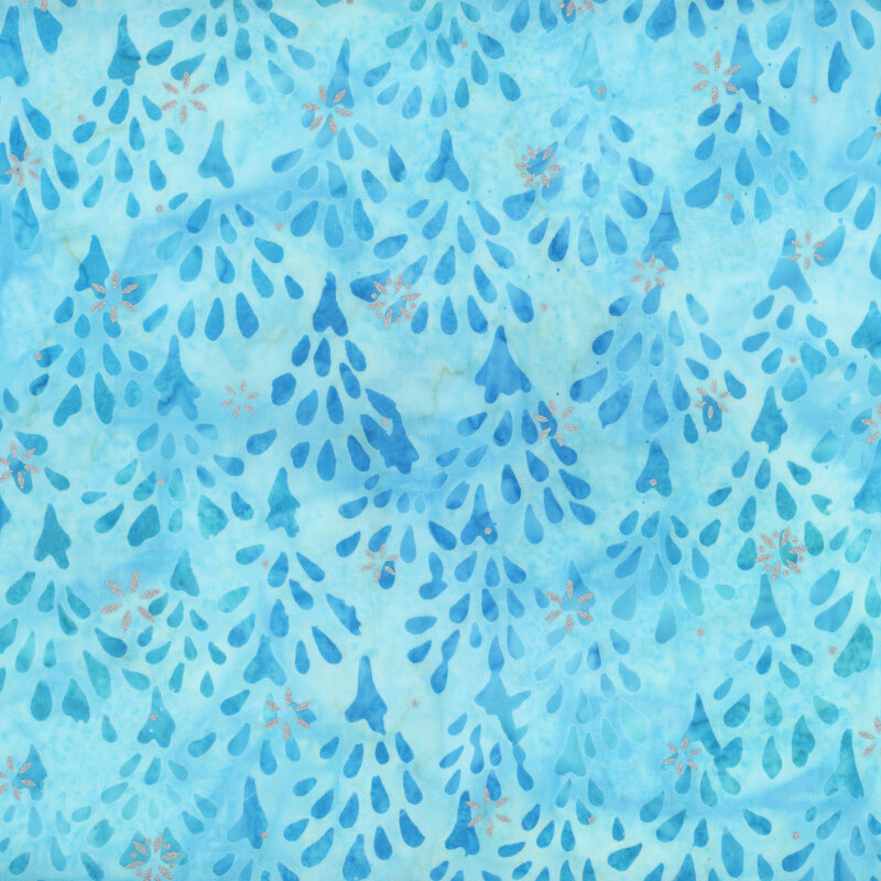 light blue mottled fabric featuring impressionistic sky blue and teal fir trees, accented with metallic silver snowflakes