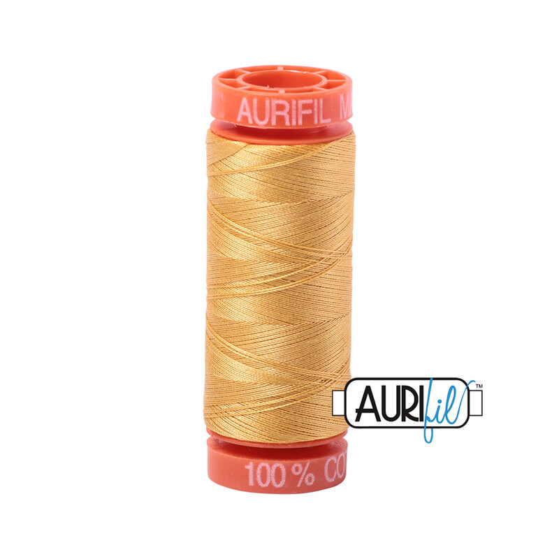 Spun Gold thread on an orange spool, isolated on a white background