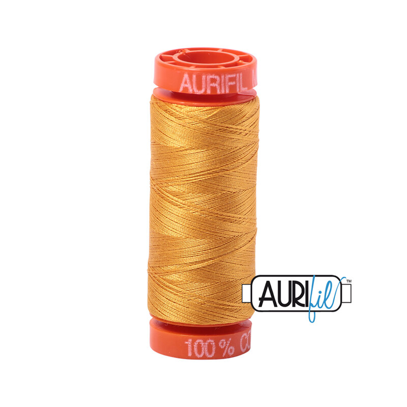 Orange Mustard thread on an orange spool, isolated on a white background