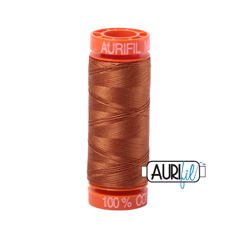 Cinnamon thread on an orange spool, isolated on a white background