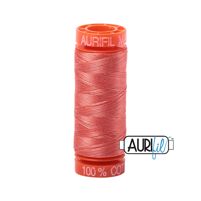 Salmon thread on an orange spool, isolated on a white background