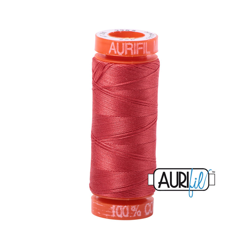 Dark Red Orange thread on an orange spool, isolated on a white background