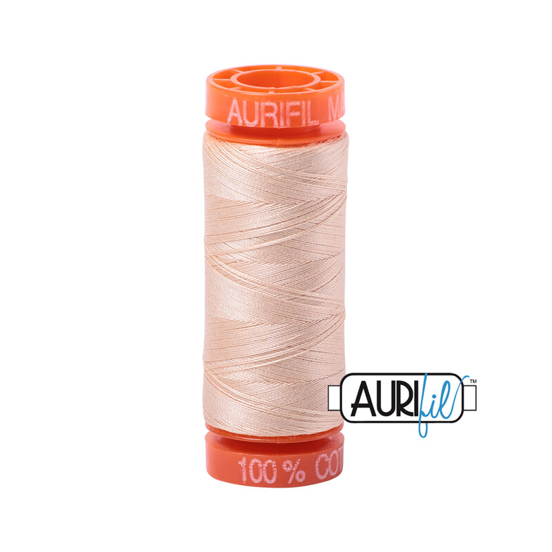 Pale flesh colored thread on an orange spool, isolated on a white background