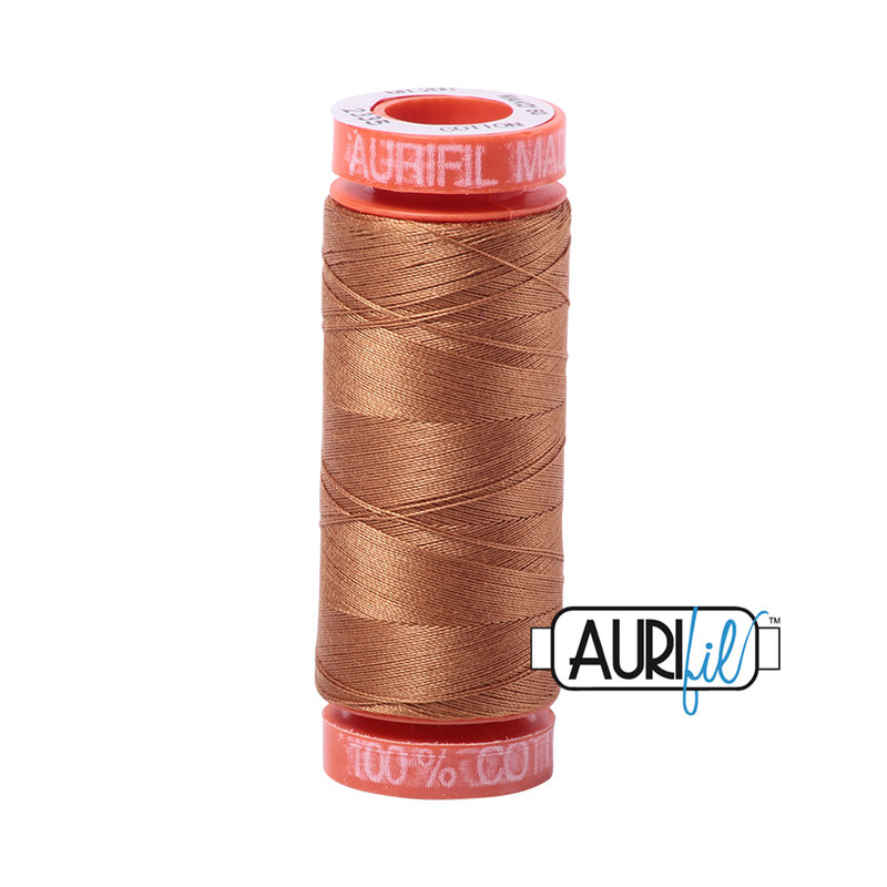 Light Cinnamon thread on an orange spool, isolated on a white background